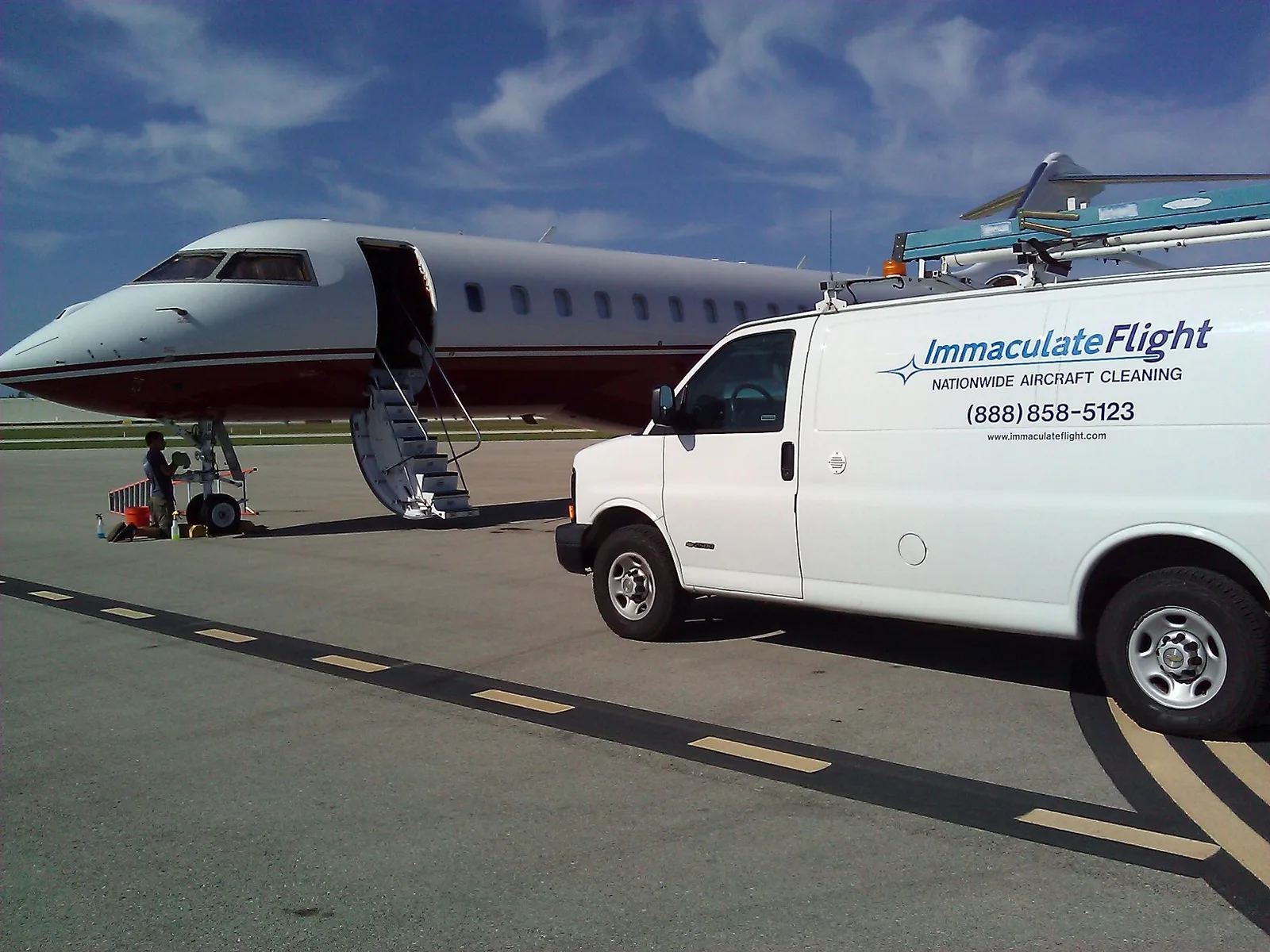 Aircraft on an airport ramp beside ground support equipment